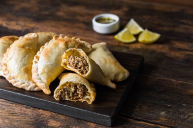 Traditional baked Argentine empanadas savoury pastries with beef stuffing.