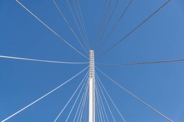 Mavi gökyüzüne karşı bir köprünün soyut geometrik mimari öğeleri.