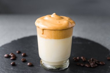 Dalgona kahveli kremalı mus, gri arka planda..