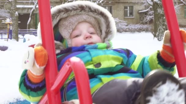 Child on swing in winter — Stock Video