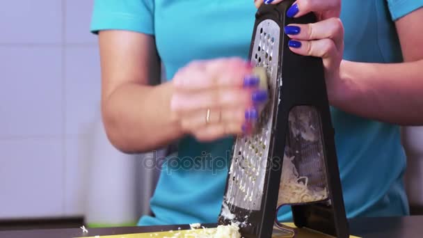 Shredding cheese on grater — Stock Video