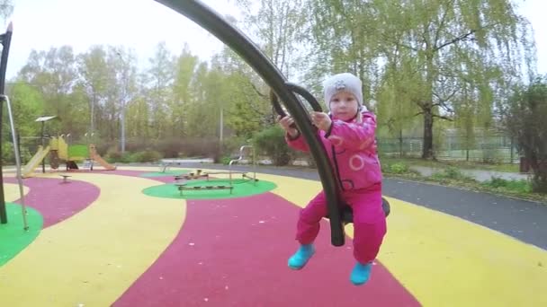 Girl child on rotating swing — Stock Video