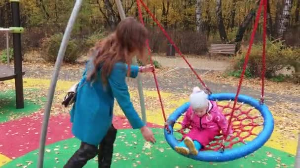 Girl child on rotating swing — Stock Video