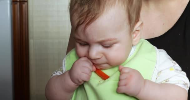 Baby boy eating a Karotka — Stock video