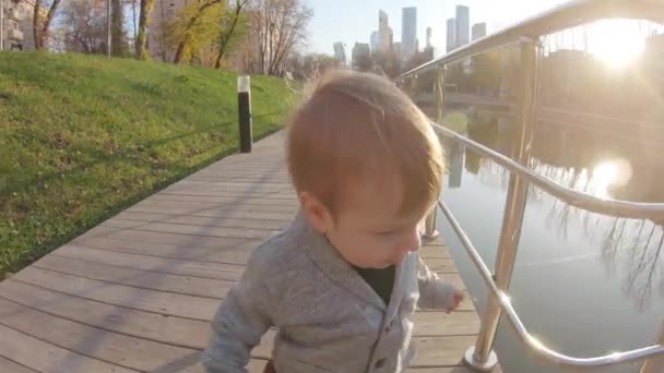 Kind jongen loopt op een houten platform — Stockvideo