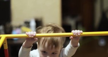 One year old boy on the gymnastic