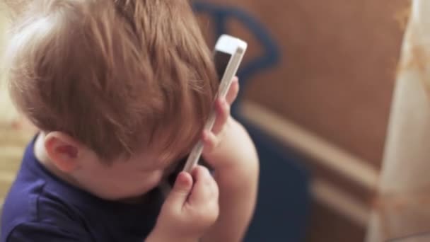 Child boy speaks on smartphone — Stock Video