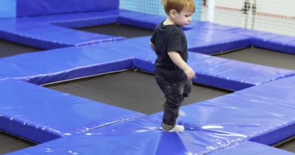 Child boy on a trampoline — Stock video