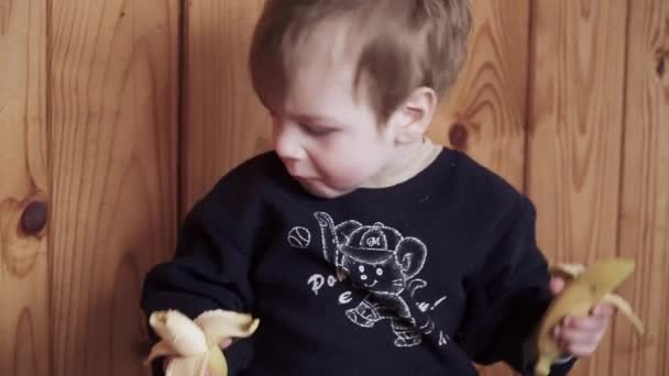 Boy in old clothes with bananas — Stock Video