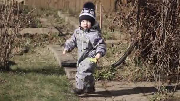 Tulumlu çocuk çimenlerde koşuyor. — Stok video