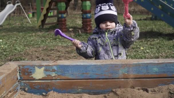 Boy plays a plastic shovel — Stock Video