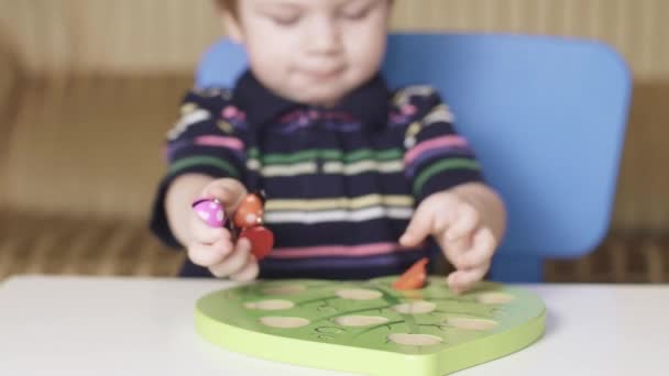 Мальчик играет в магнитную головоломку — стоковое видео