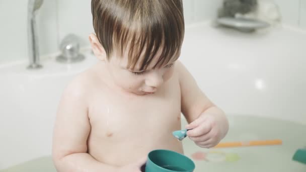 Baby boy in the bathroom drinks — Stock Video