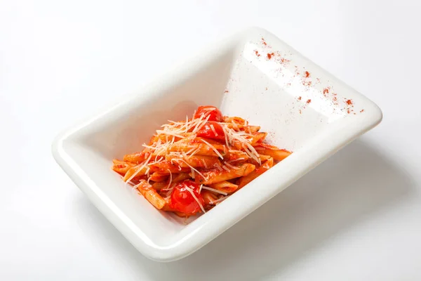 Pasta with tomato sauce sprinkled with Parmesan cheese — Stock Photo, Image