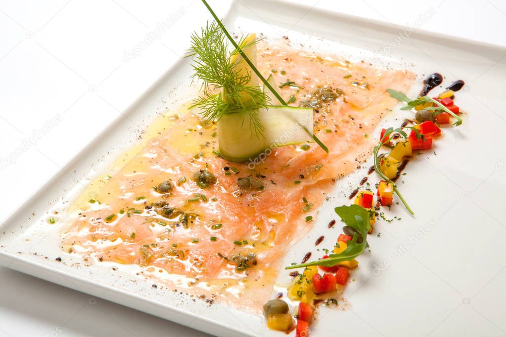Salmon carpaccio on a white plate. Seafood Carpaccio - Salmon Carpaccio