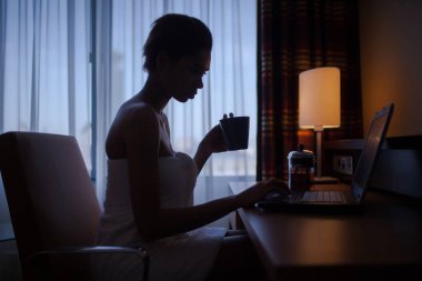 Dizüstü bilgisayar ile banyo sonra evde rahatlatıcı kadın.