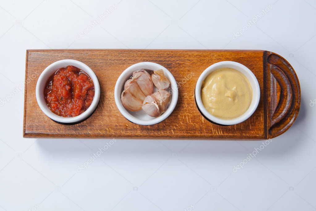 top view three sauce tomato mayonnaise and garlic sauce in white bowl isolate on wooden board