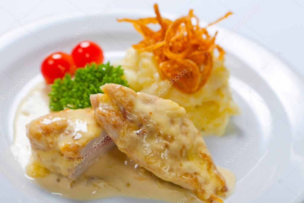 Chicken breasts chops stuffed with English bacon and cheese, served, with mashed potato
