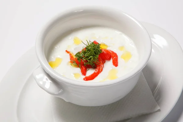Cream soup in white cup on white table background — Stock Image Cream soup in white cup on white table background Stock Photo