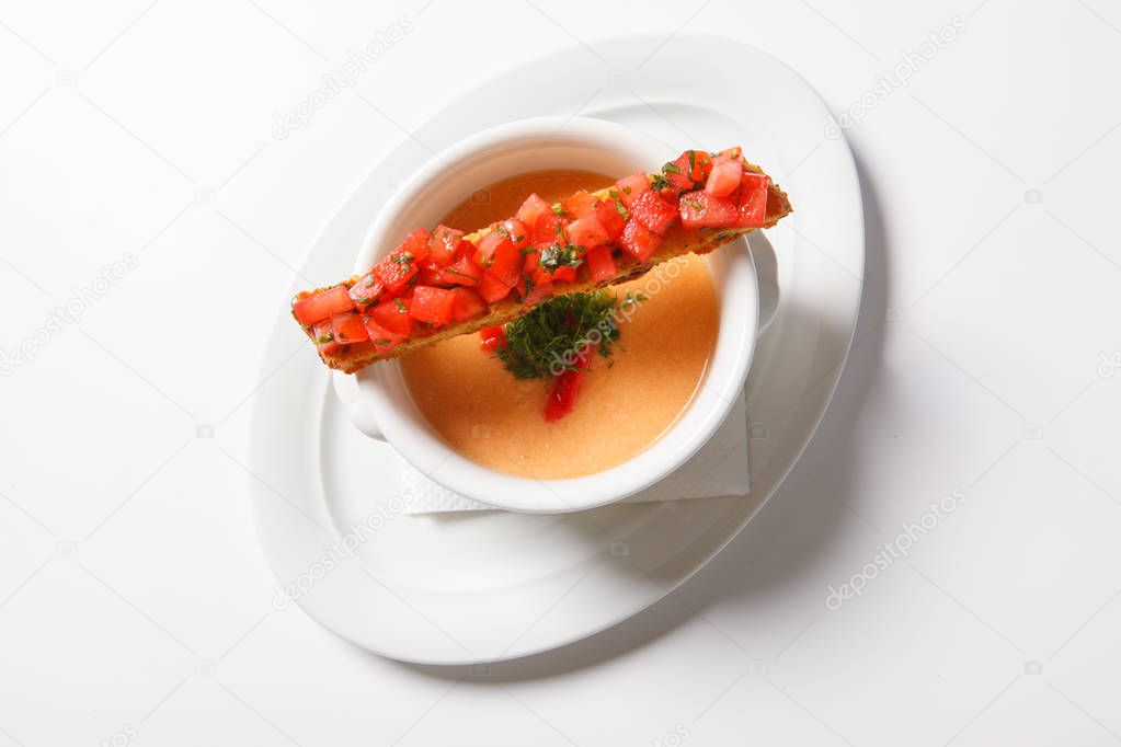 Vegetable soup with cream in deep white bowl
