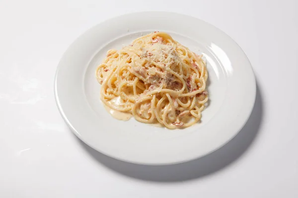 Spaghetti Carbonara with bacon and cheese on a white plate — Stock Photo, Image