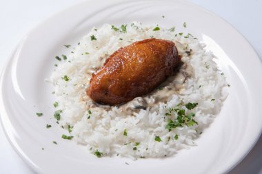 Cordon bleu pirinç beyaz bir plaka üzerinde