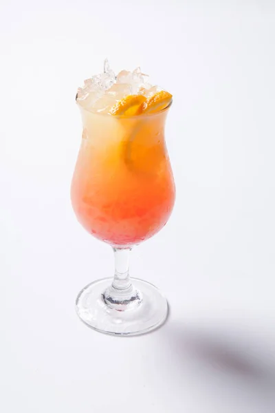 Tequila sunrise cocktail with ice on white background. Isolated
