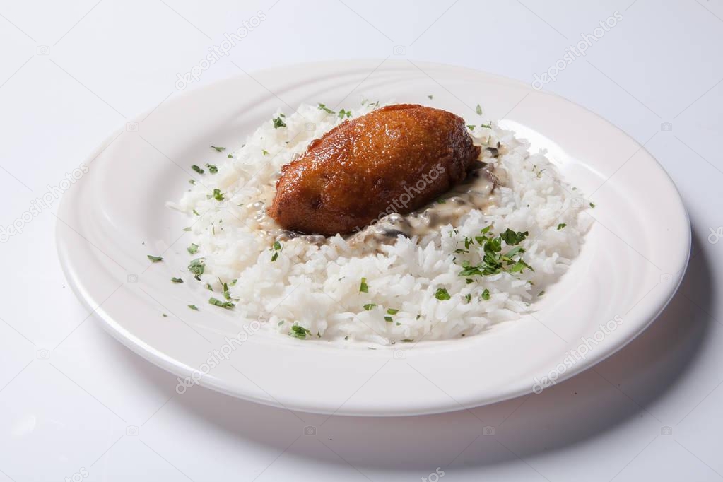 Cordon bleu with rice on a white plate