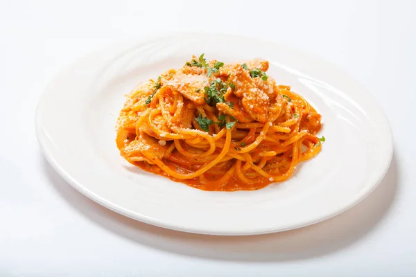 Spaghetti mit Huhn, gekocht in würziger Sauce aus Tomaten, Zwiebeln und Knoblauch. — Stockfoto