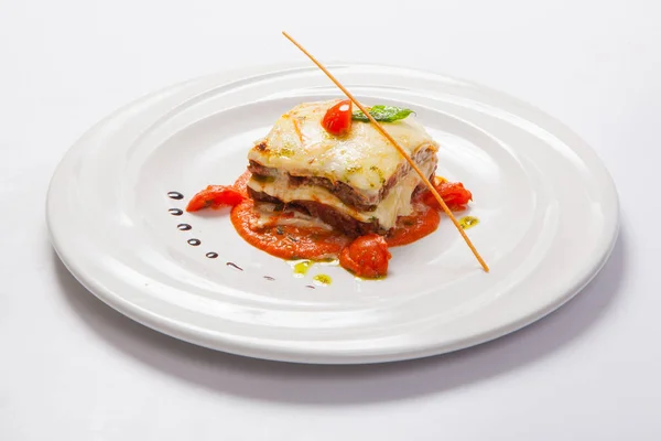 Ot ve domates soslu beyaz tabakta lazanya — Stok fotoğraf