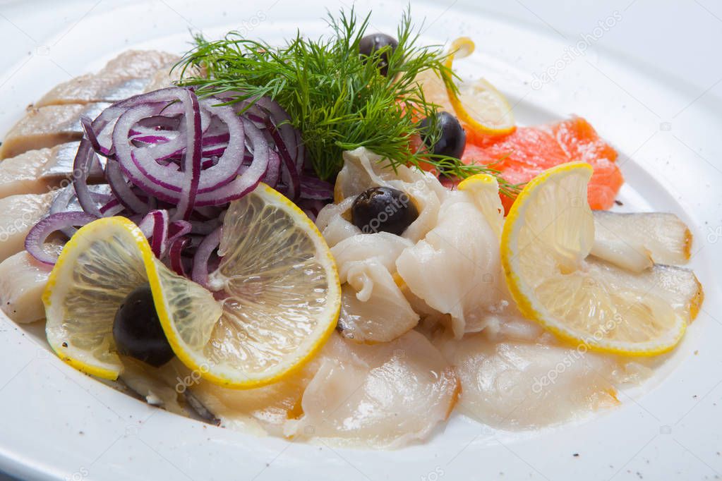 Sliced fish assortment with caviar and lemon