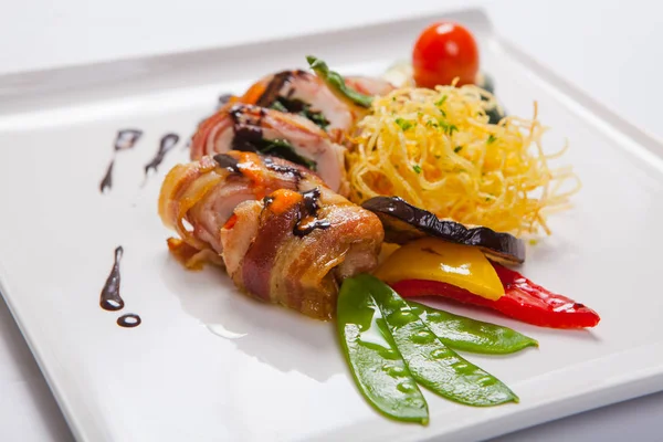 Delicious Chicken rolls with cheese and bacon on a plate close-up. horizontal — Stock Photo, Image