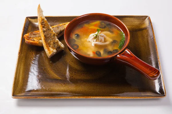 chicken soup and bread on the white background