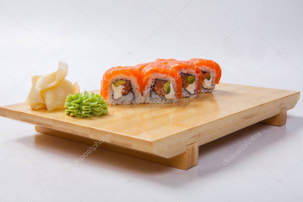 Sushi with salmon on a wooden tray