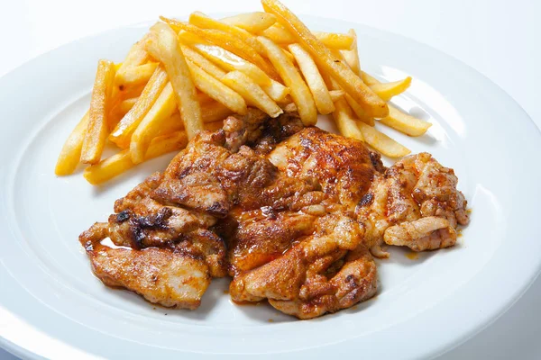 fried chicken with fries on white plate