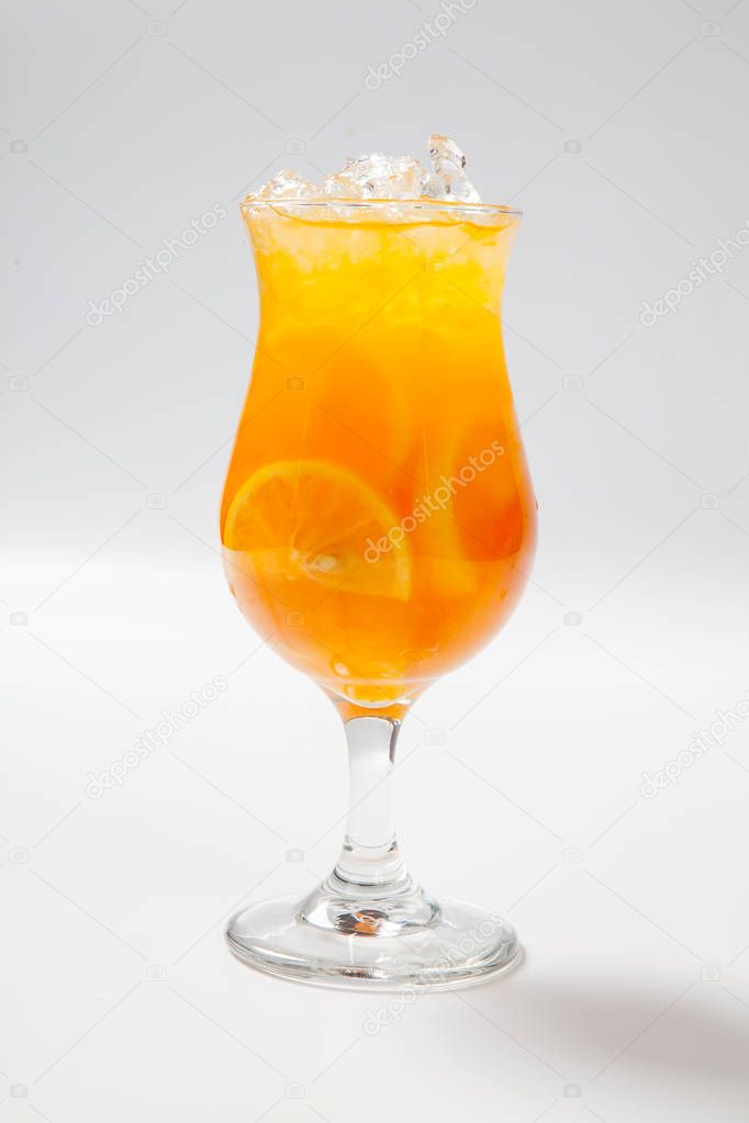 Drink with lemon, orange and ice on white background