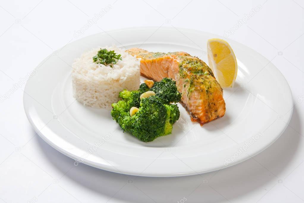 Salmon stake with boiled rise on a white background