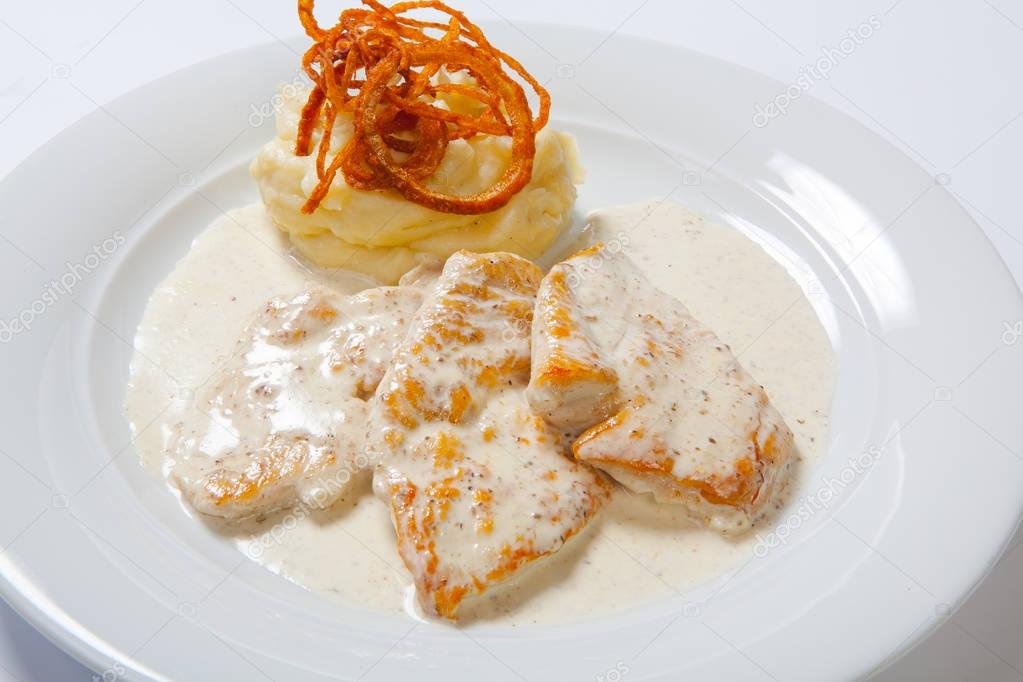 Chicken breast with mashed potato, onion and gravy