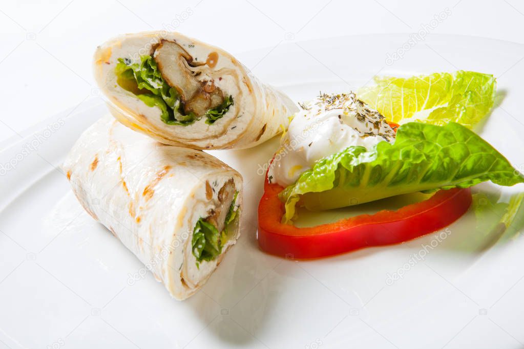 Rolls from pita bread stuffed with meat salad and cheese