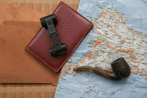 Travel planning - map with passport, shells and binoculars