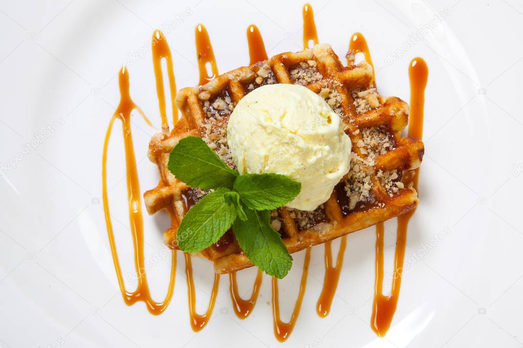 Belgian waffle with ice cream, caramel and mint