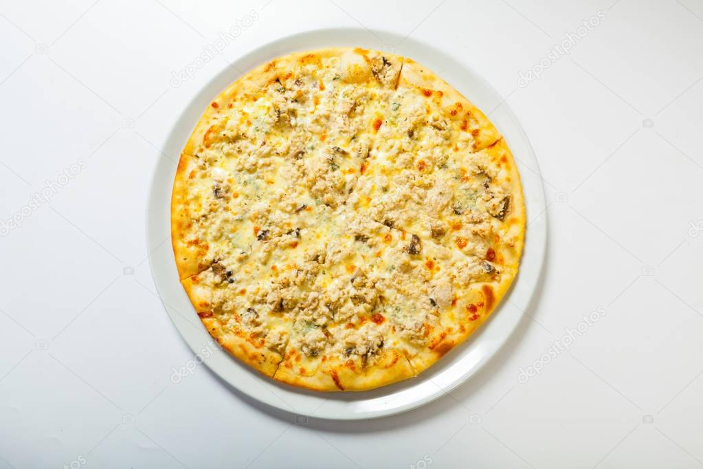 Italian delicious pizza with cheese on a white plate