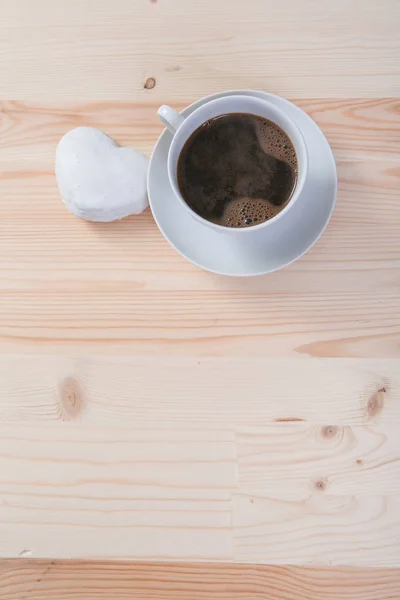 Taza de café blanco y pan de jengibre en escritorio de madera — Foto de Stock