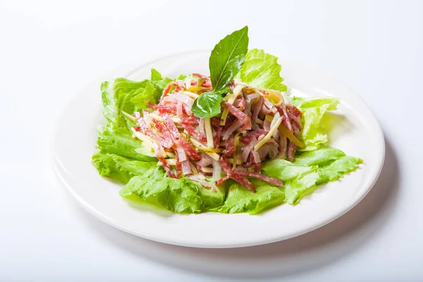 Салат из салями, ветчины и сыра на белой тарелке — стоковое фото
