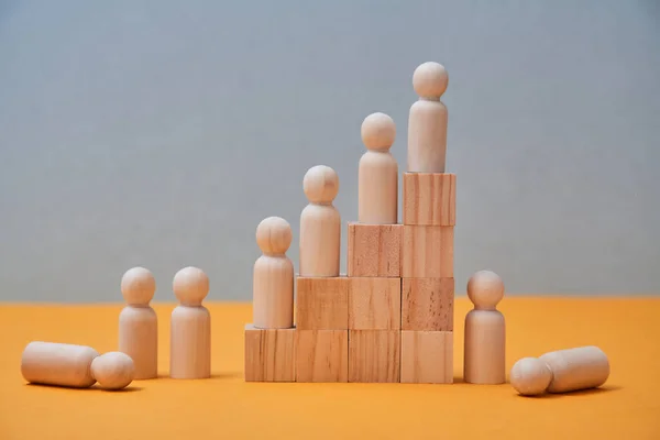 Personal, career growth mockup. Leadership, reach goal and winning. People figures on wooden pyramid steps, copy space