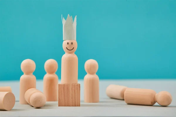 Vinner, ledarskap. Vinnare och besegrad. Kronan person figur med leende emoji på träblock, förlorare på golvet — Stockfoto