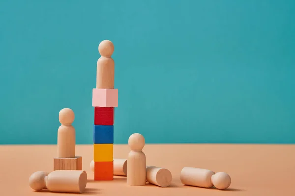 Career ladder. Reach goal and winning. Leadership, professional growth. Leader miniature on cubes top and losers down — Stock Photo, Image