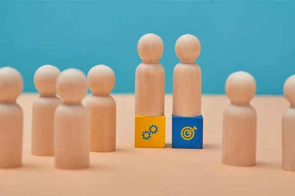Business and personal development. Career growth. Teamwork. People miniatures on cubes with target, cooperation sign