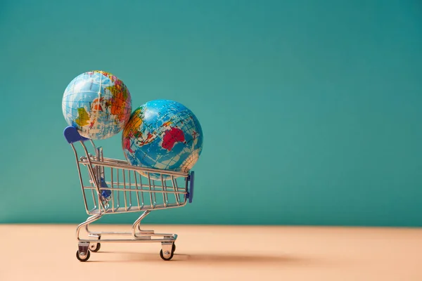 Global delivery service. Worldwide transportation. Online shopping, e-commerce. Delivery service. Trolley with globes