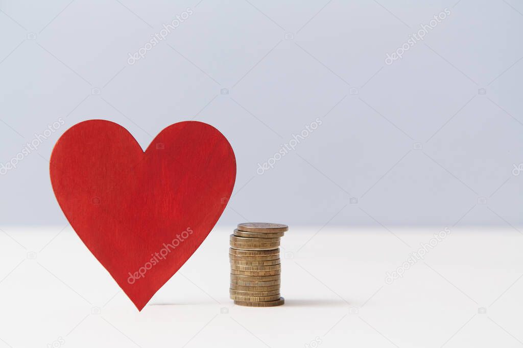 Read heart and stack of coins, copy space. Value of love. Money vs love mockup for design. Relationship versus cash